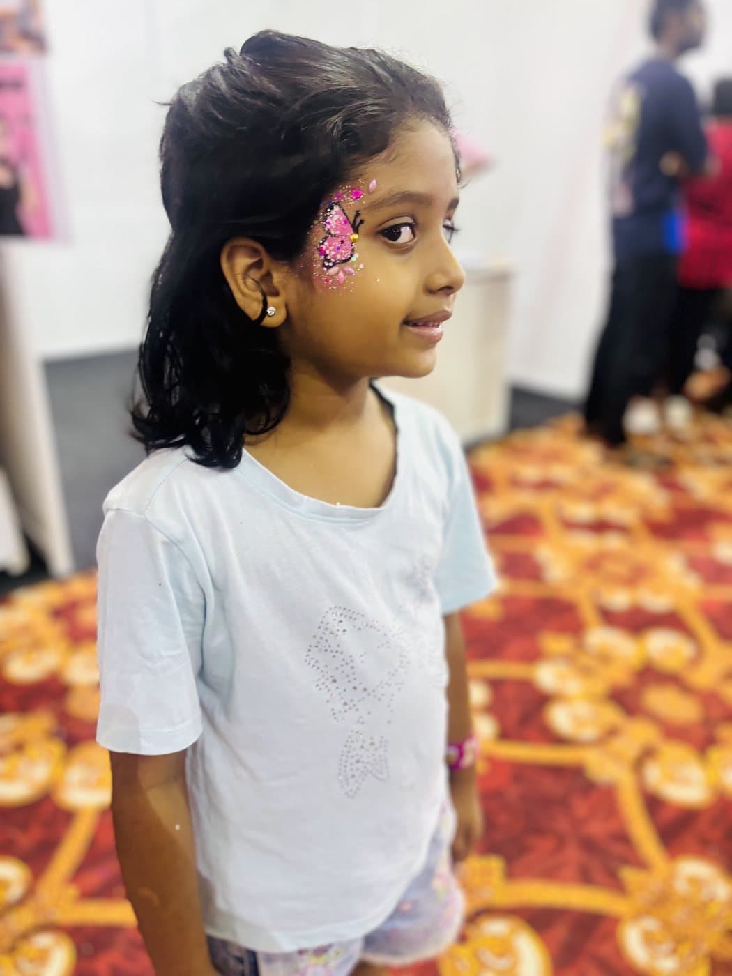 Tamaira with glittery butterfly face paint