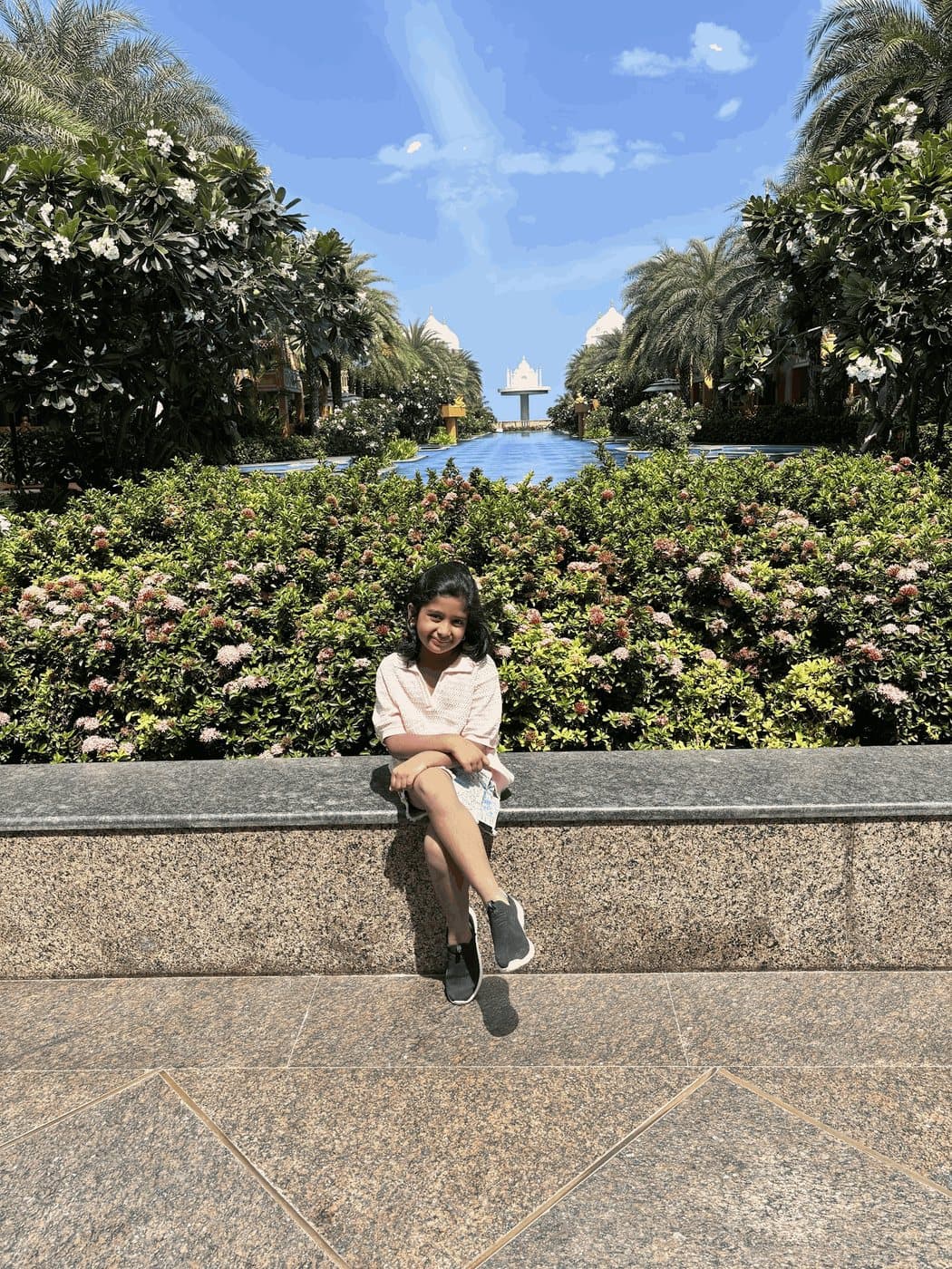 Tamaira in a sunny palm-lined garden